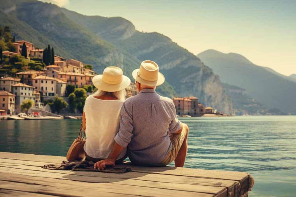 A traveling senior couple enjoying the beauty of the scenery by the lake in northern Italy